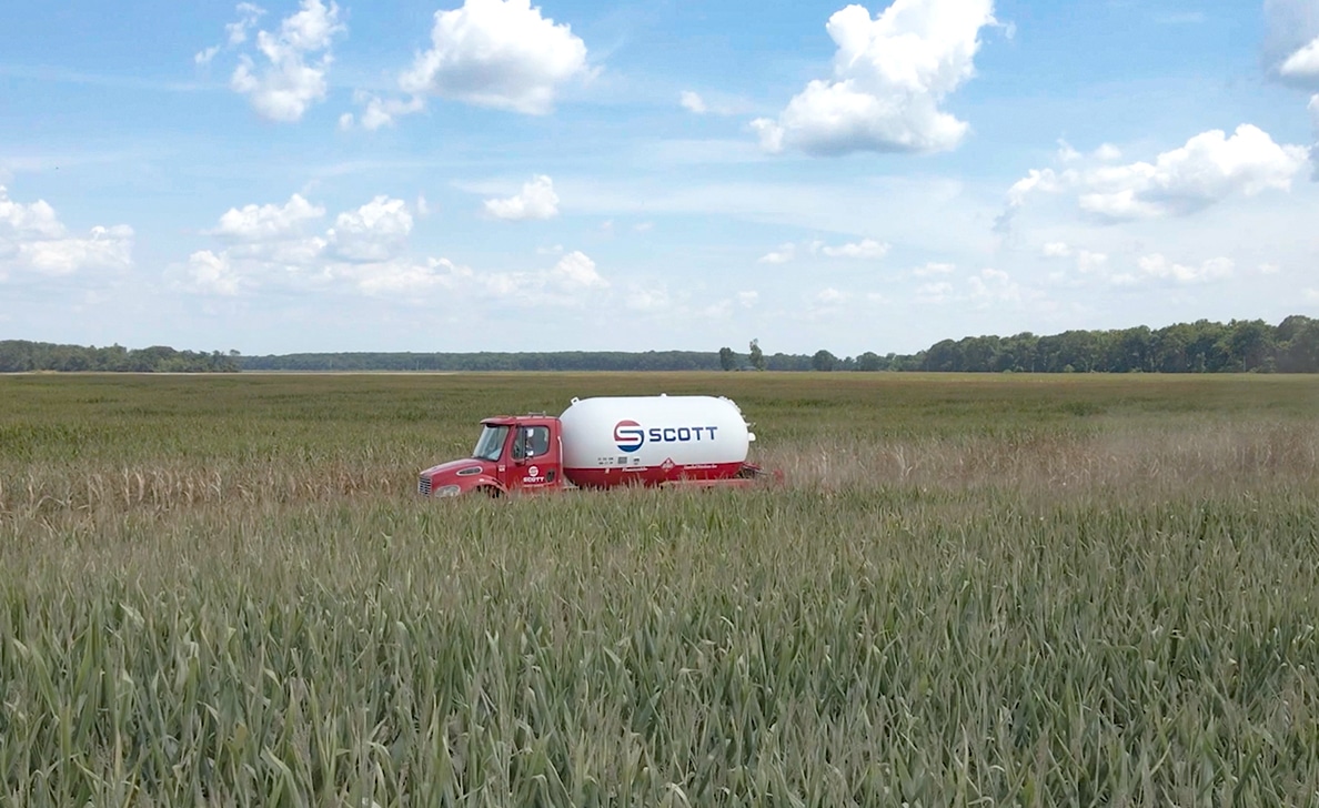 Propane truck delivering in a field