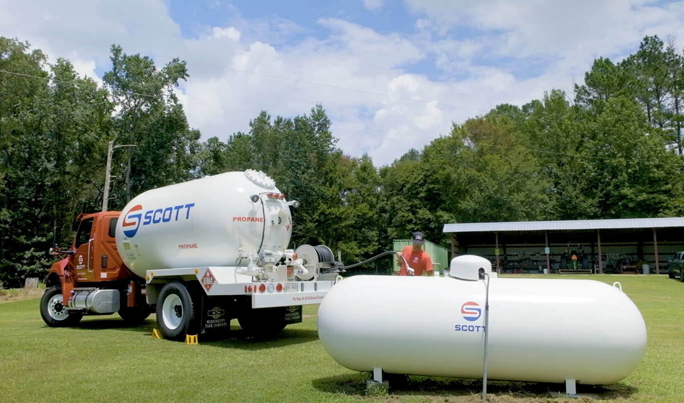 Delivery driver and truck filling residential tank